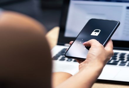 person holding a phone with a locked screen